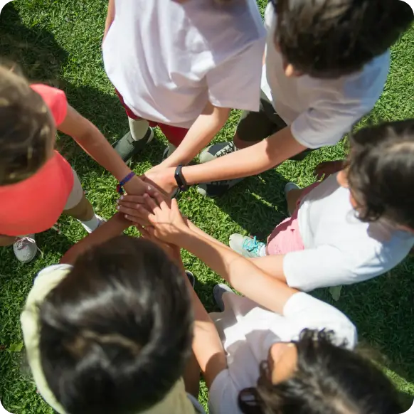 group of kids doing a team huddle