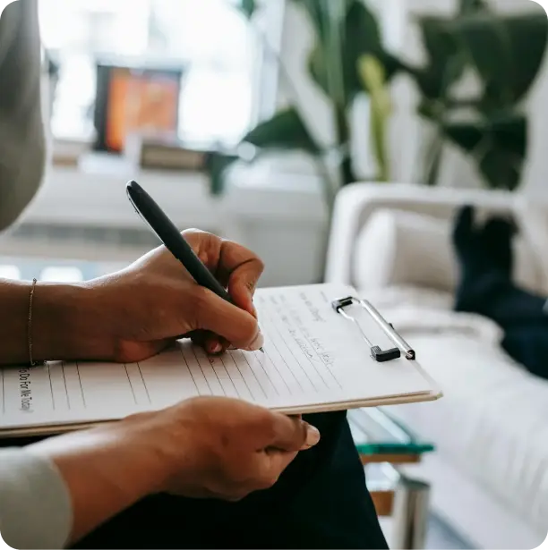 a picture of a hand writing on a form