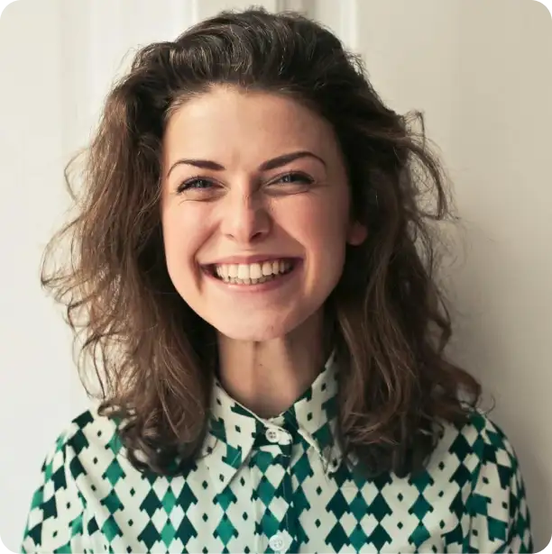 a lady with wavy hair smiling