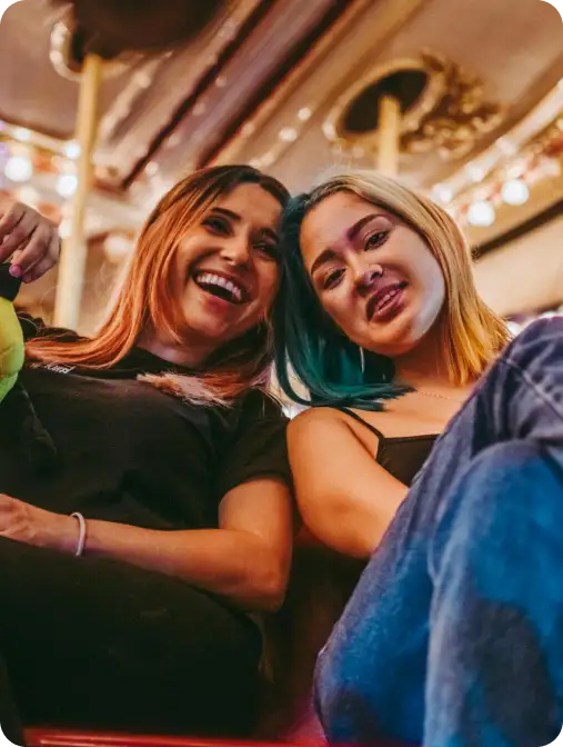 young adults posing on a staircase and in front of a brass floor lamp