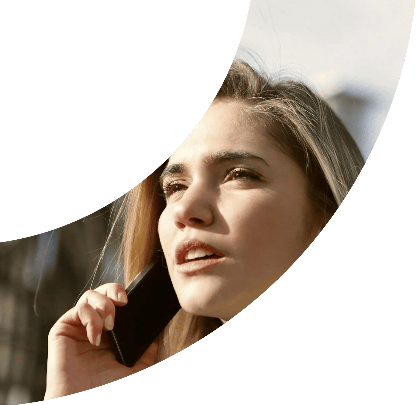 Young Woman calling someone on a cell phone and gazing into the distance