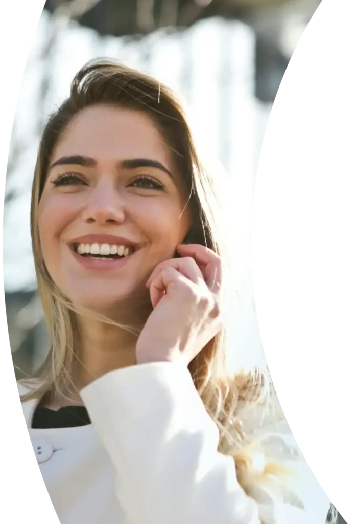 a lady happily talking to someone on her phone