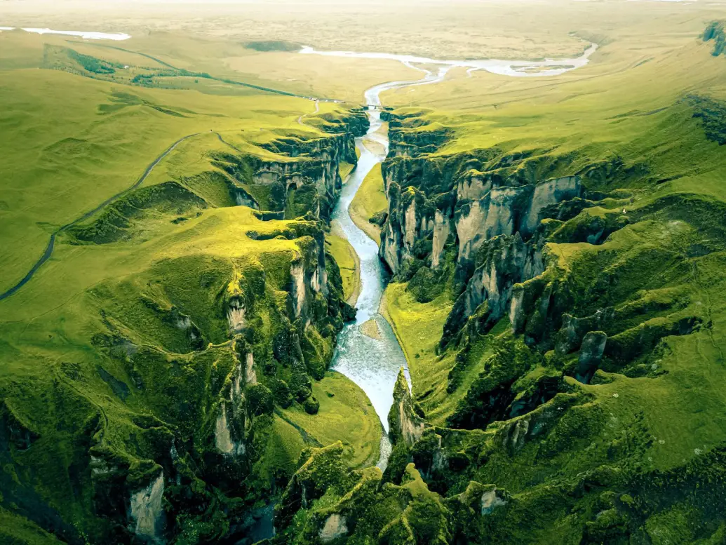 a picture of a mountain with a river in the middle