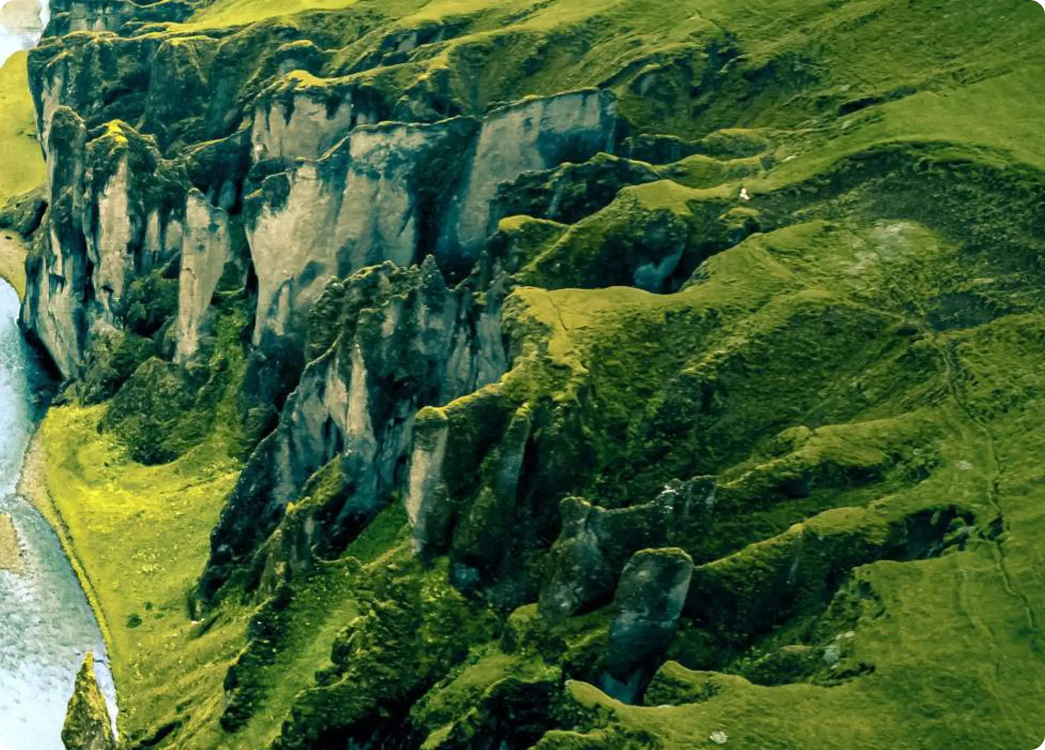 a picture of a mountain with a river on the side