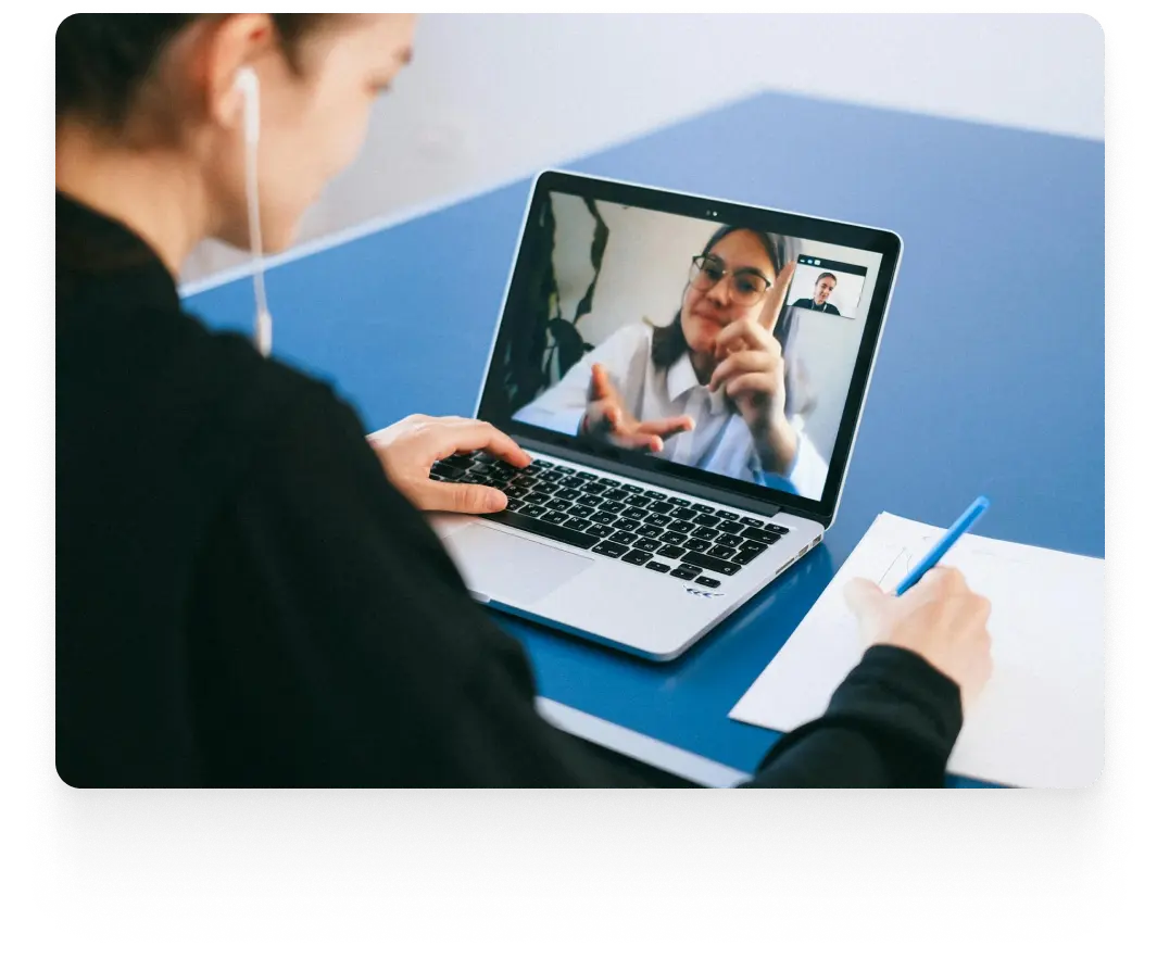 Older woman talking to 2 adults (a man and a woman) during a therapy session