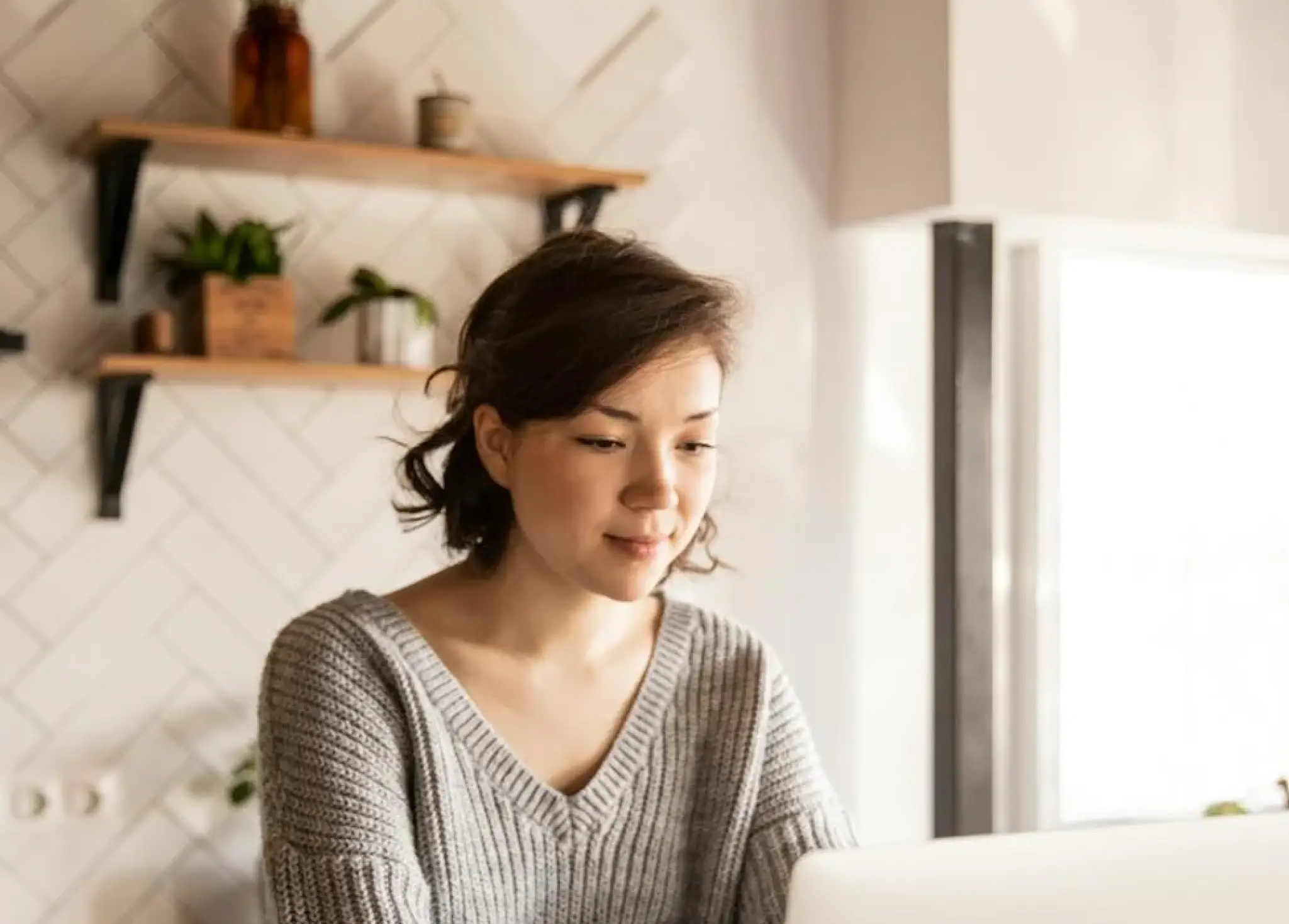 a lady looking at her laptop