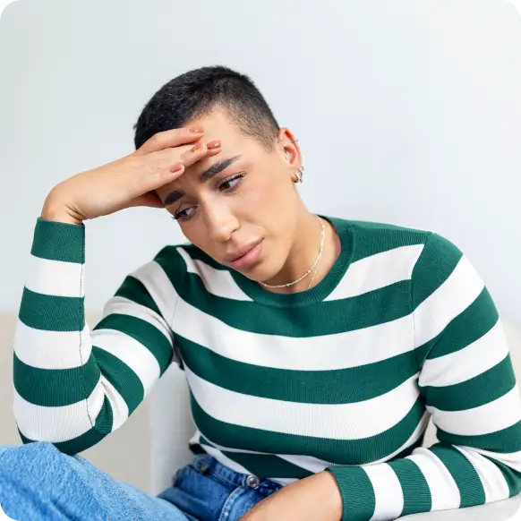 a lady with short hair holding her head