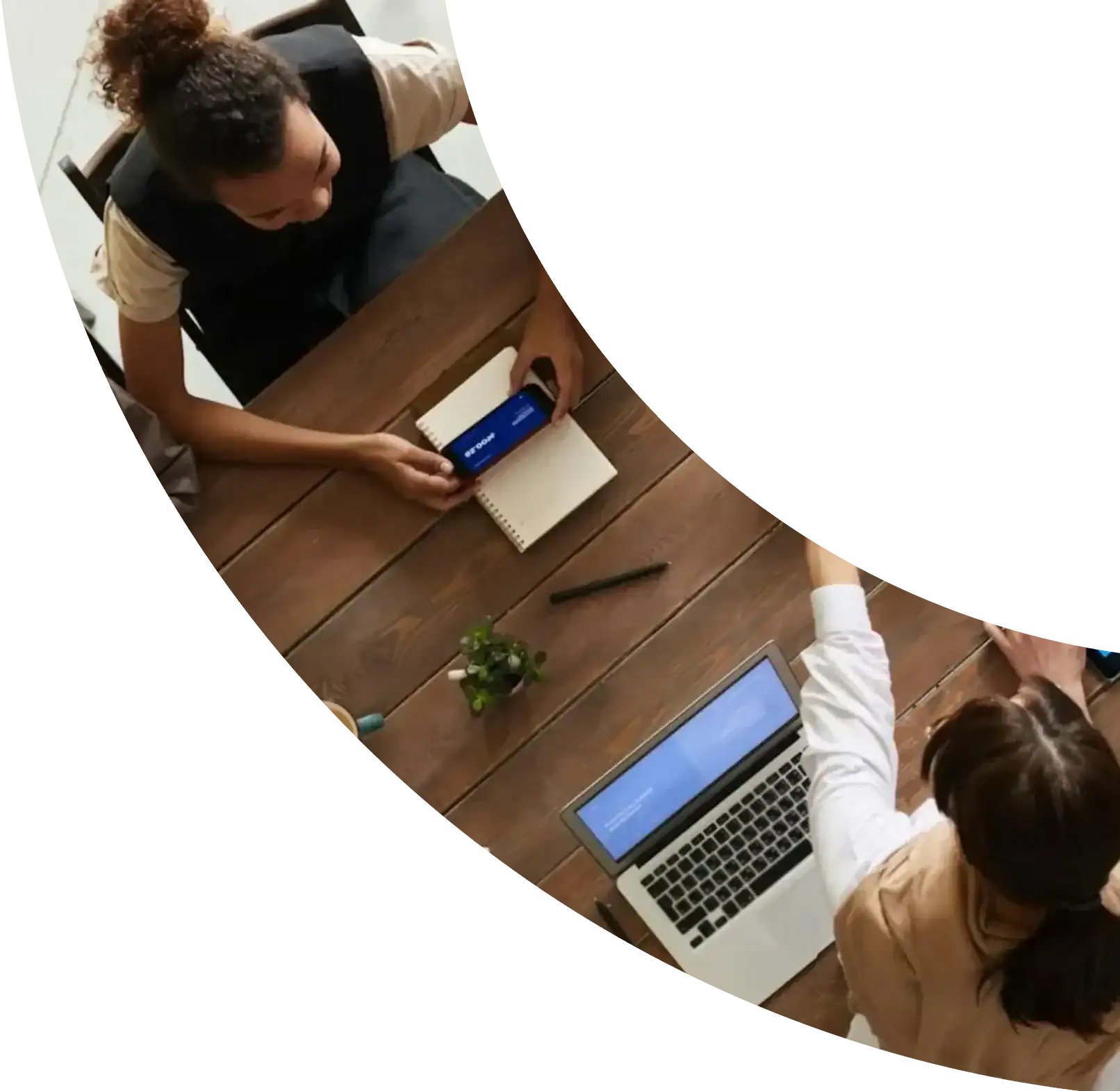 Colleagues working together around a table with laptops